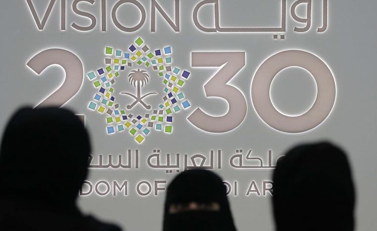  Saudi women stand next to the Saudi pavilion (Vision 2030) at the Gitex 2018 exhibition at the Dubai World Trade Centre in Dubai, October 16, 2018
