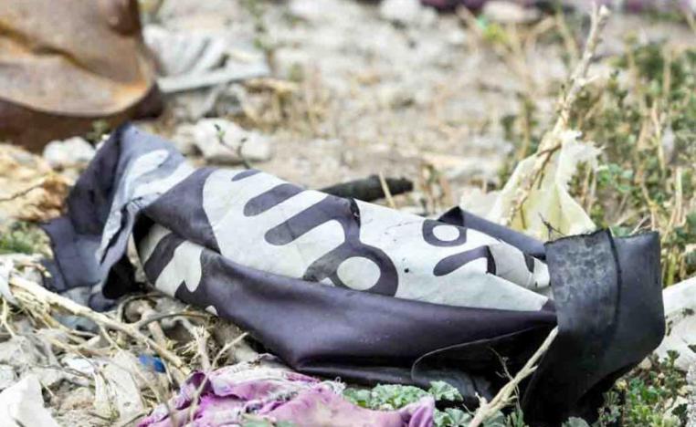 A discarded ISIS flag lies on the ground in the village of Baghouz in Syria’s eastern province of Deir ez-Zor