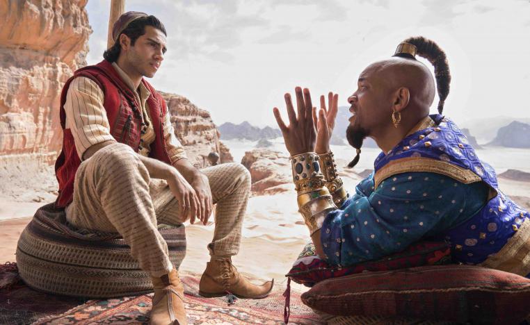 Mena Massoud as Aladdin (L) and Will Smith as Genie in Disney’s live-action adaptation of the 1992 animated classic “Aladdin.”