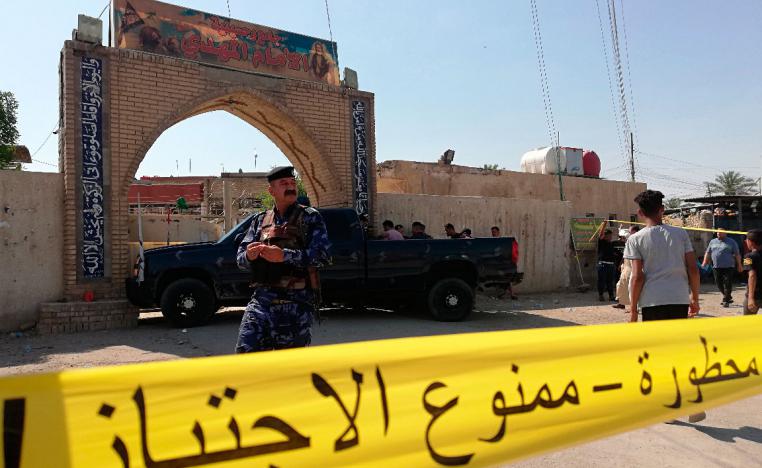 Security forces gather at the site of the attack in Baghdad
