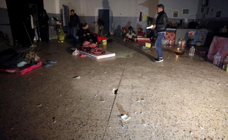 Migrants sit inside the Anti-Illegal Immigration Agency in Tajora shelter center, Tripoli