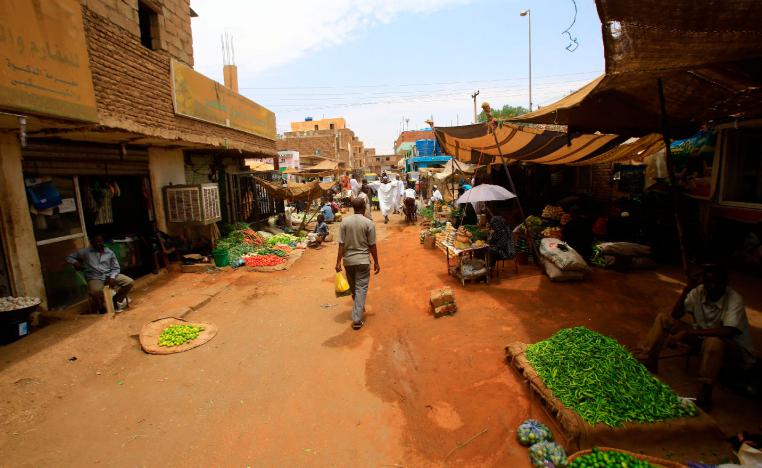 Sudanese residents walk in the central market of Khartoum