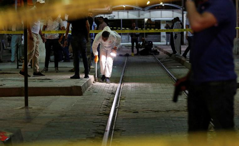 Authorities inspect the scene after a man reported to be wearing an explosive belt died in the Intilaka area in Tunis