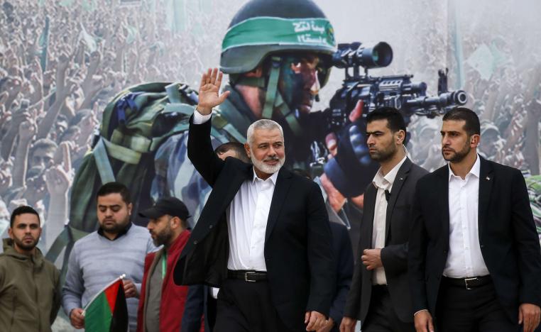 Gaza Hamas leader Ismail Haniya waves upon his arrival at a rally marking the 31st anniversary of Hamas' founding