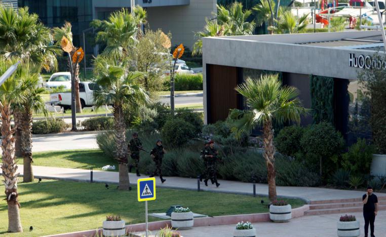 Kurdish security members are seen near a restaurant where Turkish diplomats and Turkish consulate employee were killed in Erbil