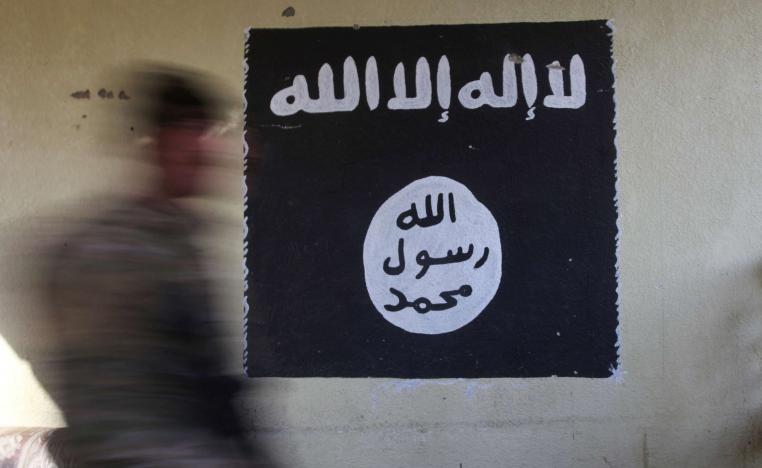 A wall painted with the black flag commonly used by Islamic State militants