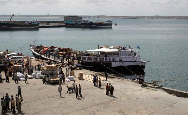  Workers stand at the sea port of the coastal town of Kismayo