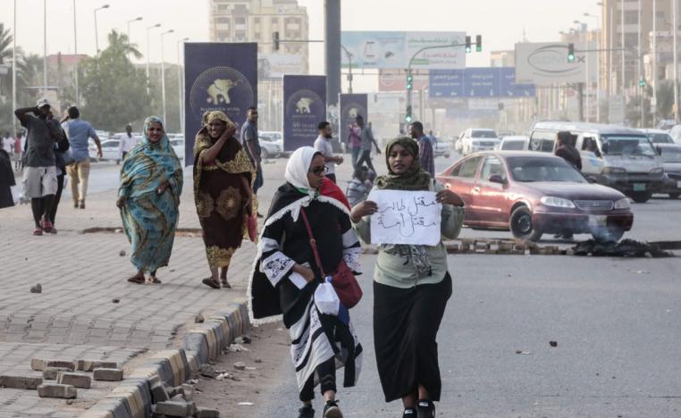 Sudanese protesters carry a placard during a rally in the capital Khartoum to condemn the killing of five demonstrators