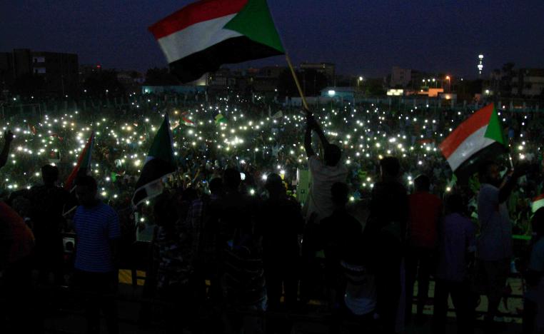 Groups of protesters sat in circles around Sudanese flags and candles in several neighbourhoods as the sun set over Khartoum.