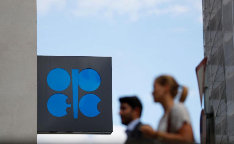 People walk outside the OPEC headquarters in Vienna