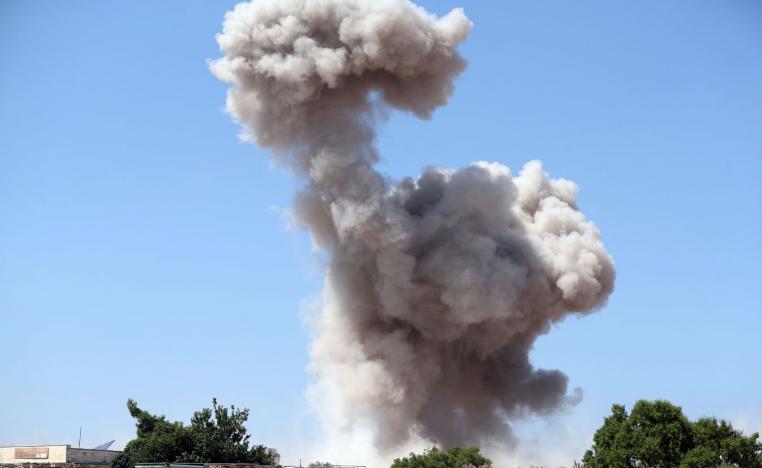 Smoke billows following a reported regime air strike in Idlib province