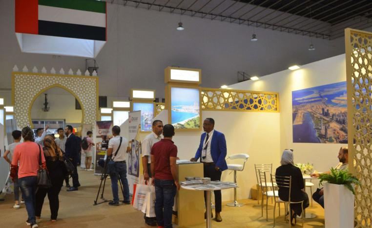 People inspect the stall of Emirati companies at the Damascus Fair in the Syrian capital