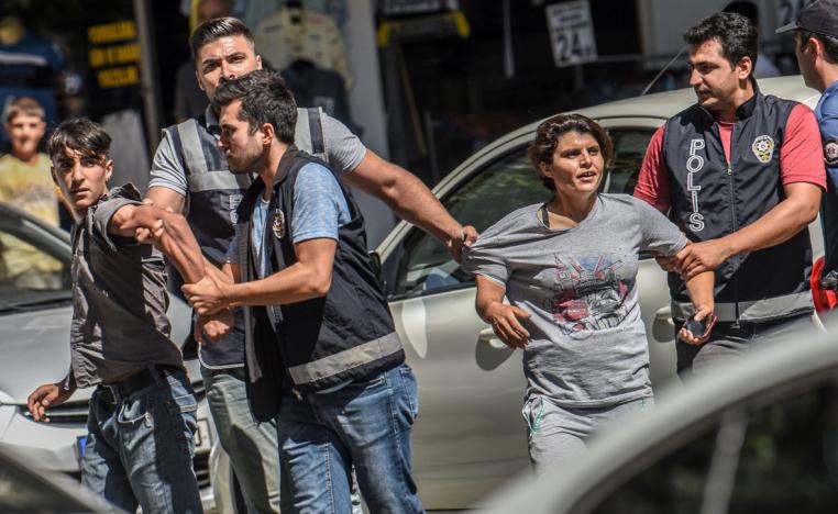 Turkish police officer detain demonstrators during a protest against the replacement of Kurdish mayors in Diyarbakir