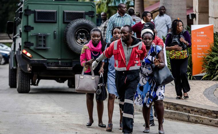 People leave a hotel complex following an explosion in Nairobi's Westlands suburb on January 15