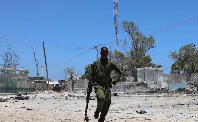 A Somali soldier runs to hold position as al-Shabaab militia storms a government building