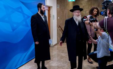 Israeli deputy Health Minister Yaakov Litzman (R) speaks to members of the media