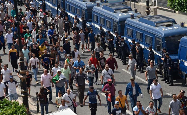 Algerian protesters take part in a demonstration against the ruling class in Algeria's capital Algiers