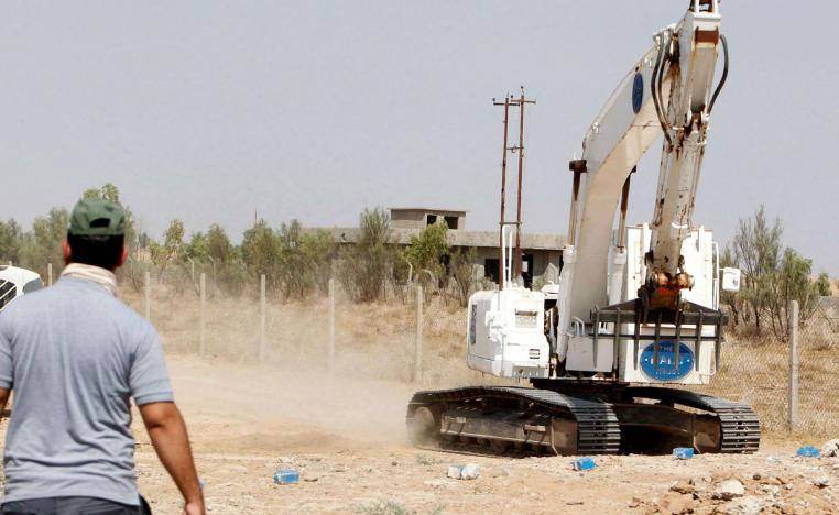 Iraqi mine clearers working with Halo Trust scan an industrial area near Iraq s Baiji