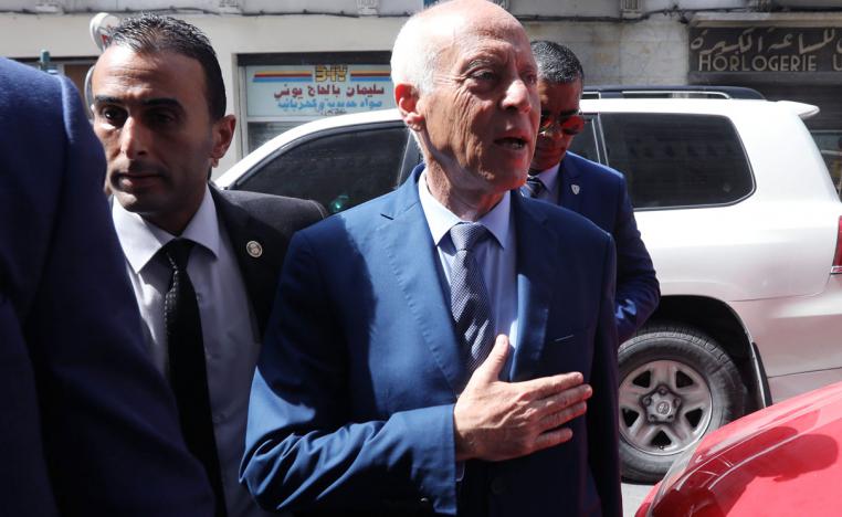 Presidential candidate Kais Saied arrives at his campaign headquarters