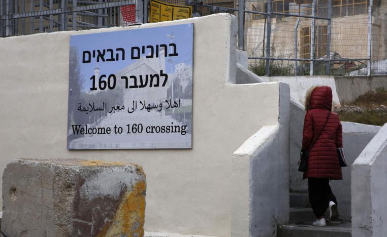 A Palestinian woman walks through the "160" checkpoint at the Ibrahimi Mosque in Israeli-occupied Hebron