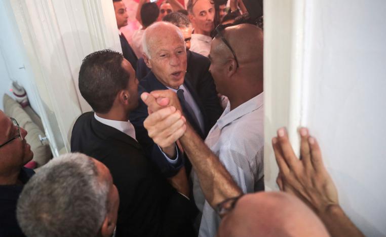 Tunisian independent law professor Kais Saied greets his supporters