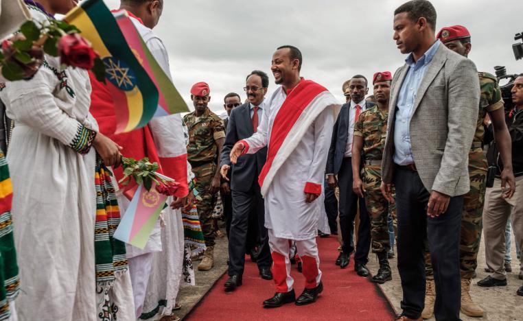 In this file photo taken on November 09, 2018 Somalia's president Mohamed Abdullahi Mohamed (CL) meets people accompanied by Ethiopia's Prime Minister Abiy Ahmed (CR)