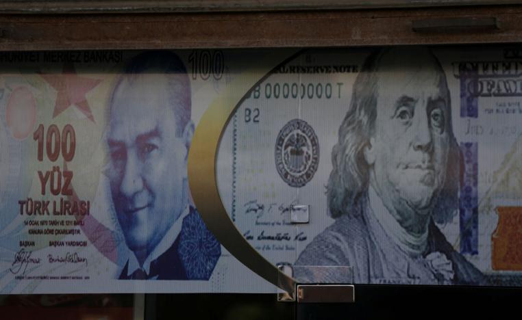 Posters of the US dollar and Turkish lira are seen on a currency exchange shop in the city of Azaz, Syria