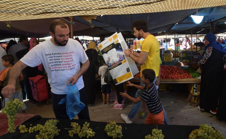 A young Tunisian from Aich Tounsi distributes campaign leaflets in the Chabaou market in Manouba