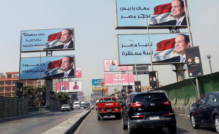Cars move along the '6th October Bridge' near banners of Egyptian President Abdel Fattah al-Sisi