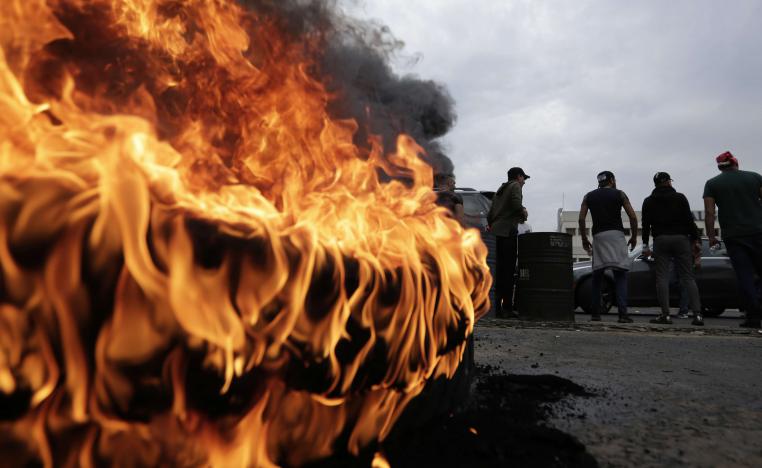 Anti-government protesters set fire to tires blocking a highway that link the Capital Beirut to north Lebanon