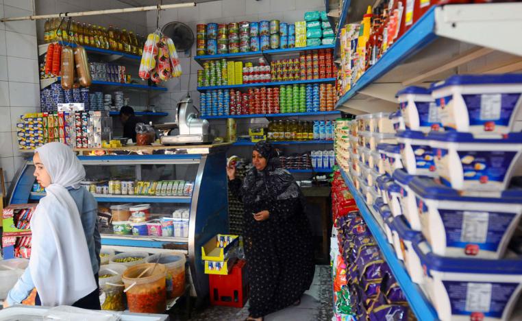 People shop inside a market in Giza, Egypt