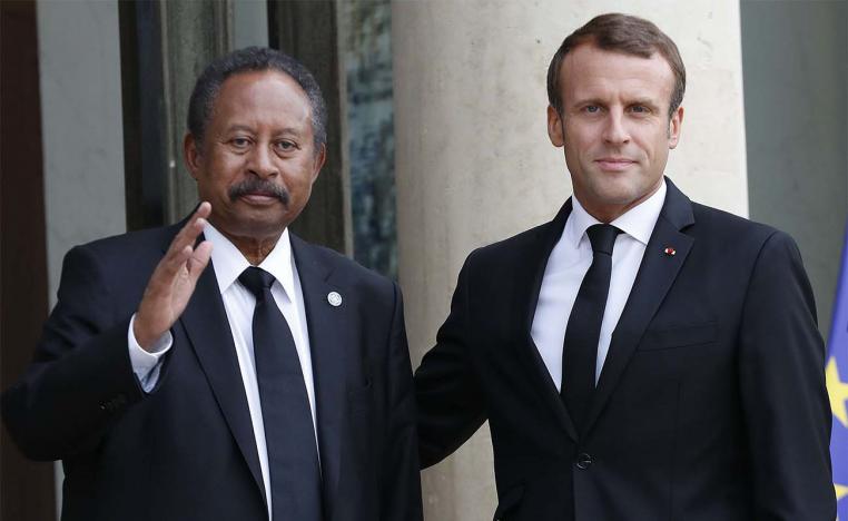 French President Emmanuel Macron welcomes Sudanese PM Abdalla Hamdok prior to a meeting at the Elysee palace in Paris