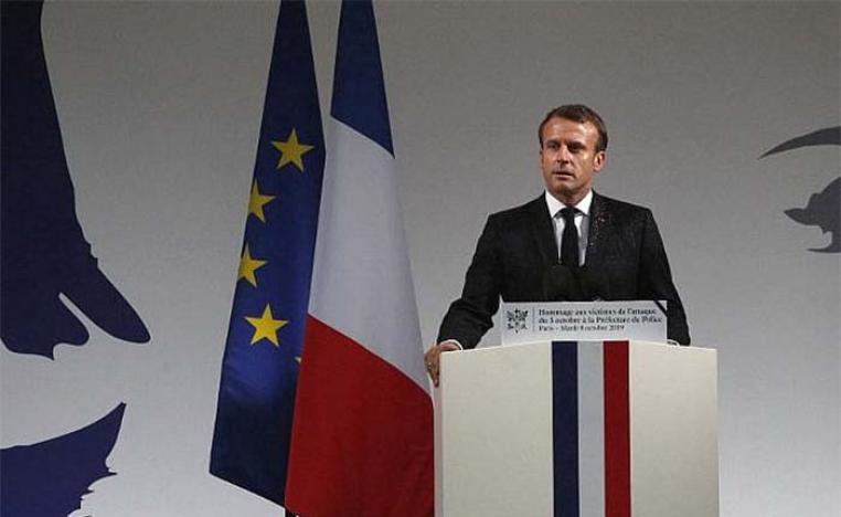 Macron addressing a ceremony at the Paris police headquarters where the attack took place