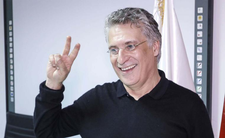 unisian presidential candidate and media magnate Nabil Karoui poses for a picture at his campaign headquarters after his release