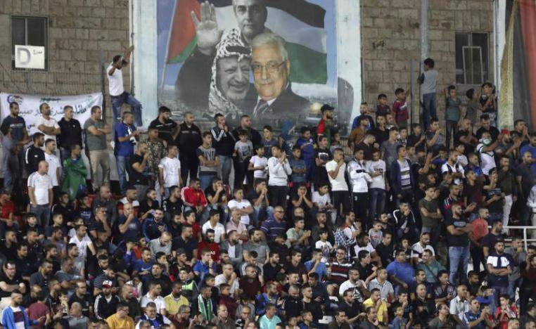 Spectators watch a match between Palestinian team Hilal al-Quds and Morocco's Raja Casablanca in the Arab Champions Cup at Faisal Husseini stadium in the town of al-Ram