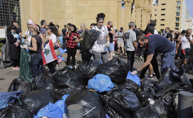 On the square, female volunteers scoop up piles of used half lemons -- some with rind curling off them -- and burnt trash.