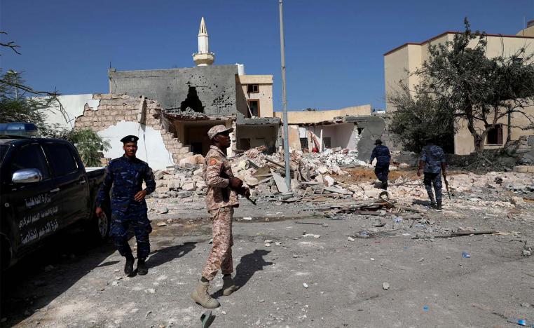 Security members inspect the site of the air strike