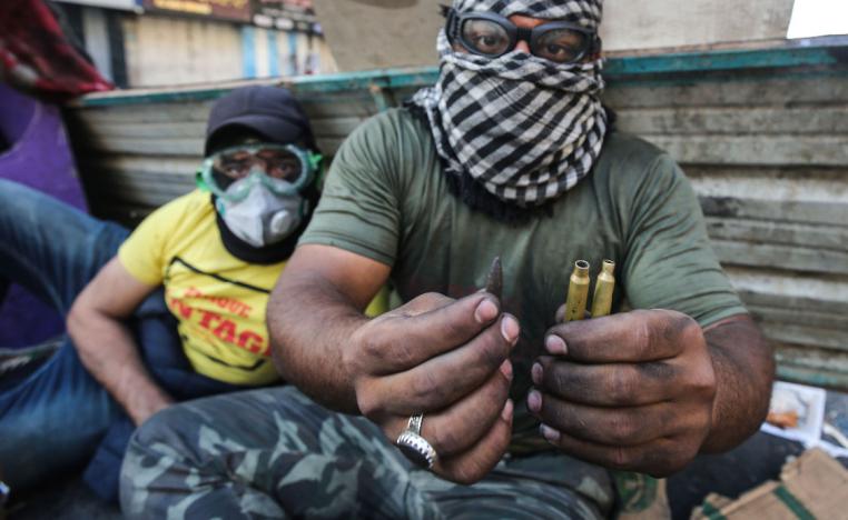 An Iraqi protester shows bullets amid clashes with security forces at Baghdad's Khallani square