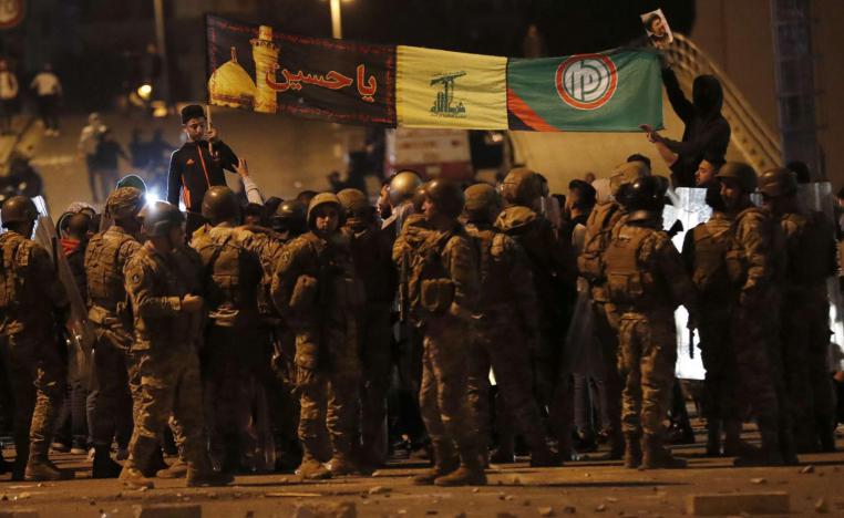 Army soldiers and riot police formed a barrier separating the protesters from the supporters of the Shi'ite groups