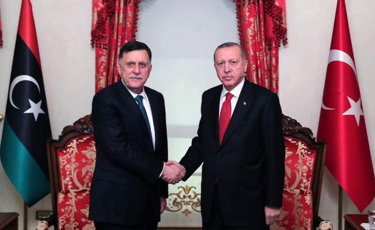 Turkish President Recep Tayyip Erdogan (R) shakes hands with Chairman of the Presidential Council of Libya Fayez al-Sarraj