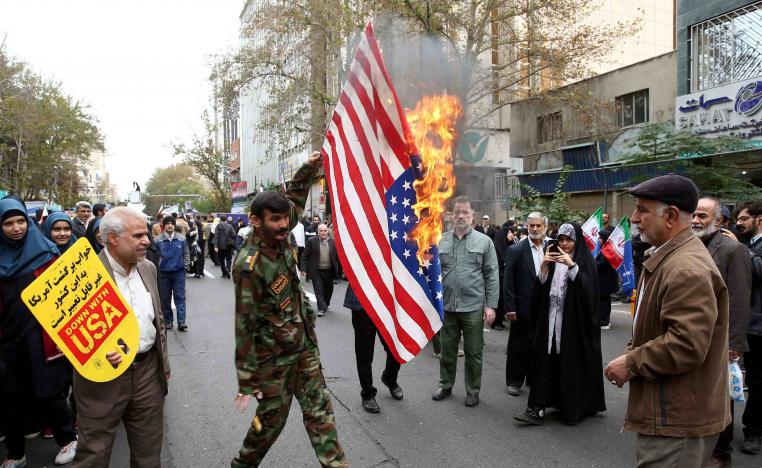 Iranians massed in front of the building carrying placards with slogans such as "Down with USA" and "Death to America."