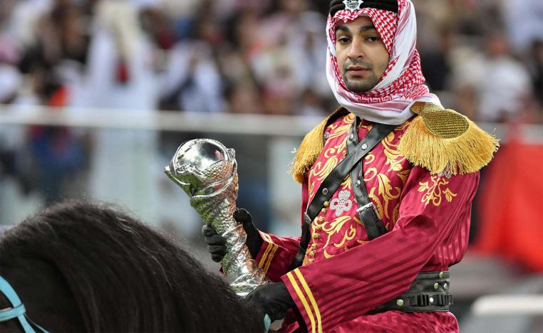 A mounted policeman wearing a traditional outfit arrives with the trophy prior to the Gulf Cup of Nations 2017 final football match 