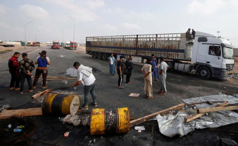 Iraqi demonstrators block the entrance to Umm Qasr Port during the ongoing anti-government protests