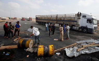 Iraqi demonstrators block the entrance to Umm Qasr Port during the ongoing anti-government protests