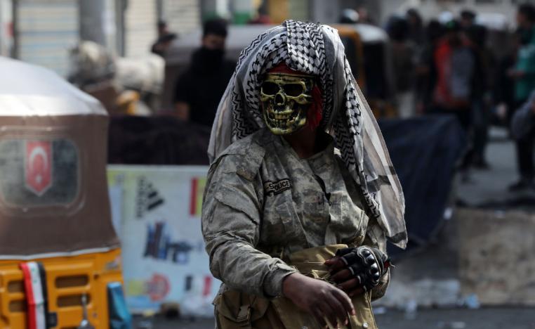An Iraqi demonstrator wears a mask during ongoing anti-government protests in Baghdad