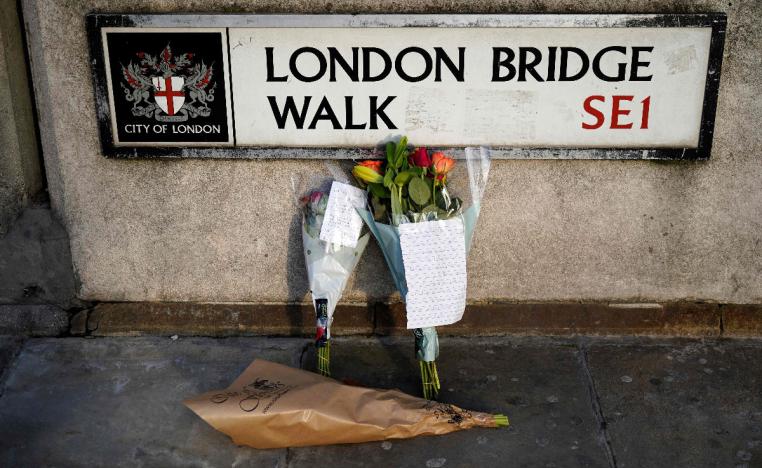 Floral tributes are pictured close to London Bridge in the City of London