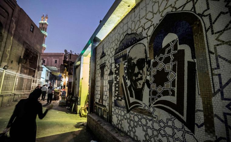 A mural depicting Egyptian novelist and nobel prize winner Naguib Mahfouz is pictured behind the al-Azhar mosque in downtown Cairo 
