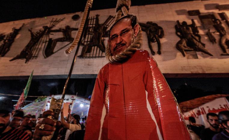 A bust of Former Iraqi Prime Minister Nuri al-Maliki is placed near a symbolic gallows
