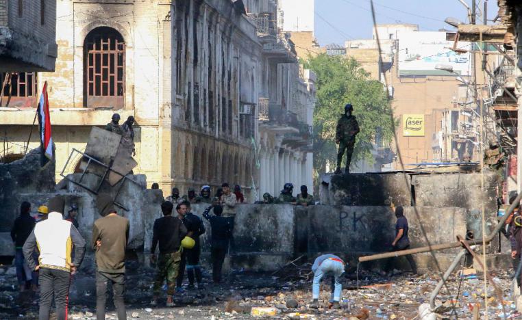 Iraqi demonstrators rally in Al-Rashid Street near the central bank in the capital Baghdad