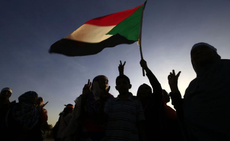 Demonstrators wave the Sudanese flag in Khartoum
